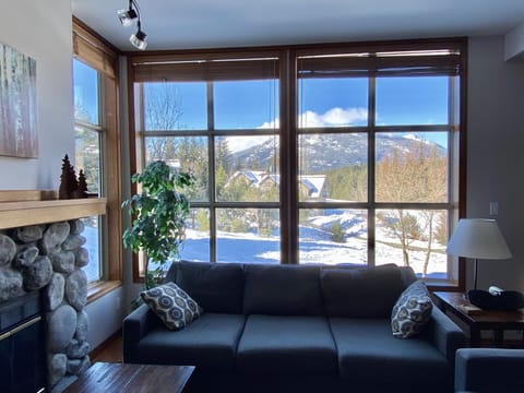 Picture windows define the living area, opening up to gorgeous mtn & golf views