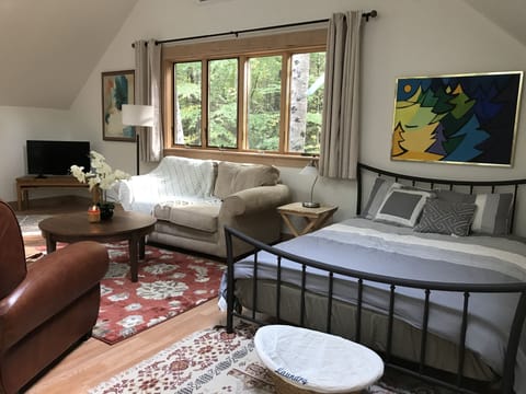 Relaxing area with comfortable couch and chairs. TV with Netflix.