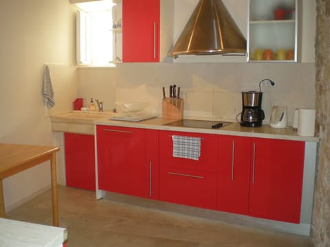 Modern, fully equipped kitchen with solid top cookers and dishwasher.