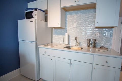 Kitchenette has a standard size coffee maker  and other small appliances