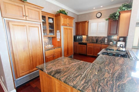 Kitchen with gas stove and subzero freezer and refrigerator