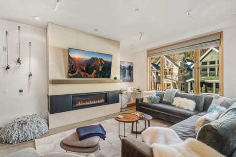 Elegant and inviting living room featuring a sophisticated gas fireplace, refined modern design, and a warm, family-friendly atmosphere.