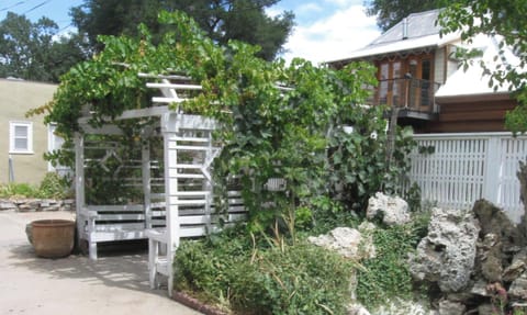 Gather beneath the pergola in this leafy courtyard