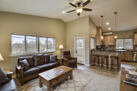 Gather around leather seating and a rustic coffee table
