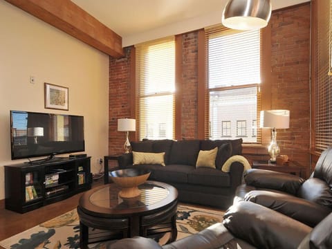Welcome to your historic loft sanctuary, featuring soaring 11-foot ceilings, exposed original brick feature walls, and grand timber support beams.