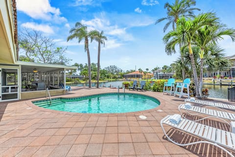 Step into your own tropical oasis with a private heated pool overlooking the peaceful canal.