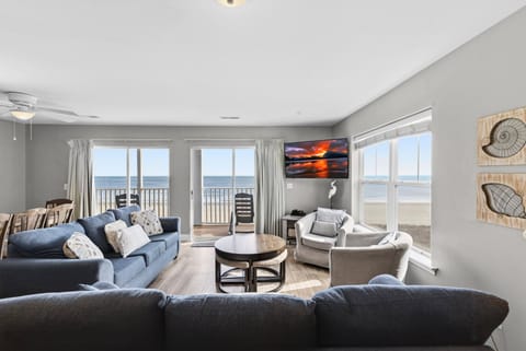 Living Room - Open living area with seating arranged around a TV, providing a place to relax after a day of activities. With oceanfront views.