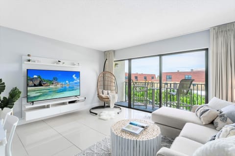 Enjoy your favorite shows on a 65" smart TV with streaming apps in this bright and cozy living area.