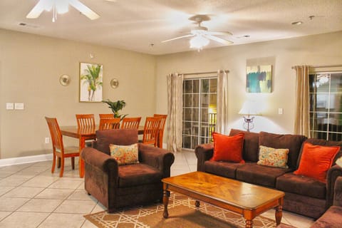 Open-concept living and dining space with warm tones and direct access to the patio—perfect for family meals and movie nights.