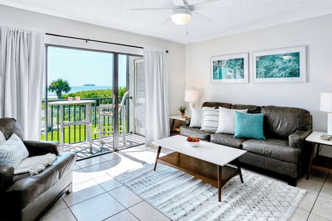 Bright, beautiful, and beachy living space with balcony access