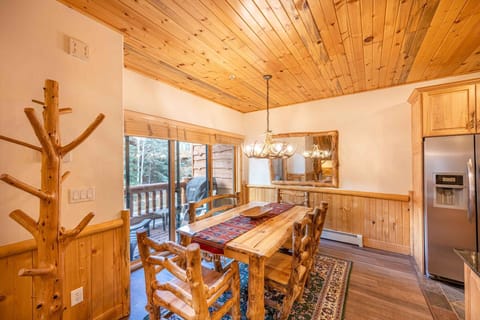 The warm and inviting dining room is a perfect place to enjoy a family meal - we have a gorgeous knotty pine hardwood table with 4 chairs and a comfor
