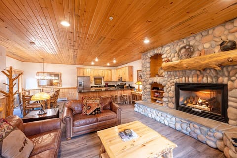 The comfortable overstuffed leather sofas perfectly frame the hand laid river-stone mantle and gas fireplace. There is also a 48" HDTV with cable