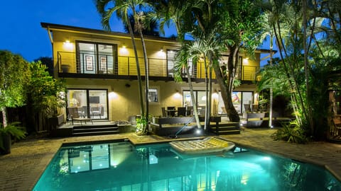 House, pool and garden by night
