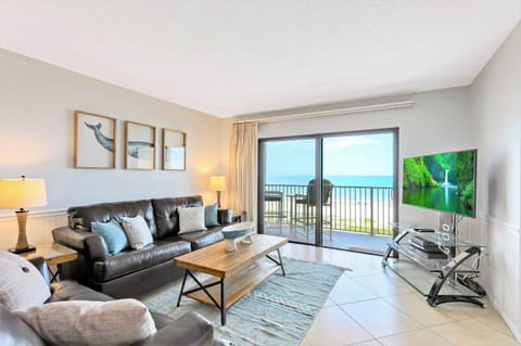 Bright and airy living room opens to a private balcony with ocean views