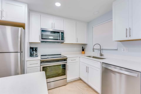 A sleek kitchen, ready for morning coffee and seaside meals.