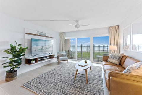 Stylish and inviting living space with large windows overlooking the beach