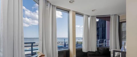This sunroom is bathed in natural light, with sweeping bay views that create a peaceful, airy retreat for morning co