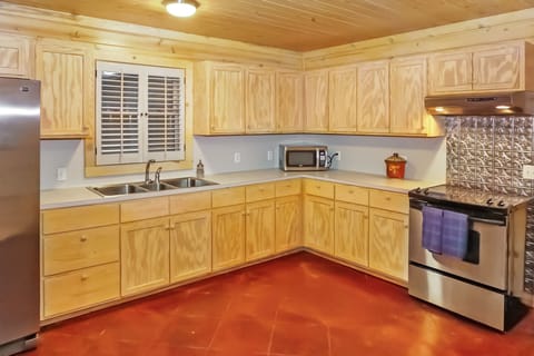 Large kitchen with stove, oven, refrigerator, microwave, and coffee maker