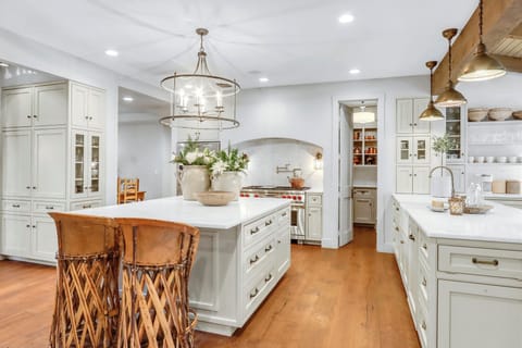 Step into this stunning chef's kitchen where elegant white cabinetry meets warm brass fixtures, creating your perfect culinary haven for memorable meals - Main House