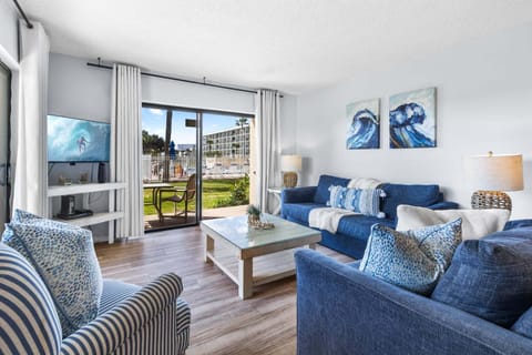 Closest Canaveral Tower condo to the ocean! Bright and modern living room with a coastal-inspired design.