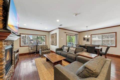 Relax in your spacious living room with cozy seating around the warm fireplace, perfect for unwinding after mountain adventures.