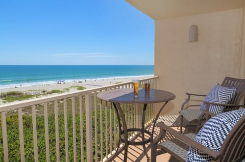 Private balcony with a table and chairs, offering a peaceful spot to enjoy ocean views.