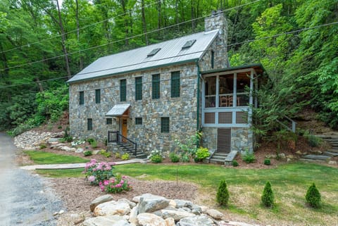 Nestled on 7 acres along Mackey Creek, this secluded stone cottage captures the essence of refined mountain living!