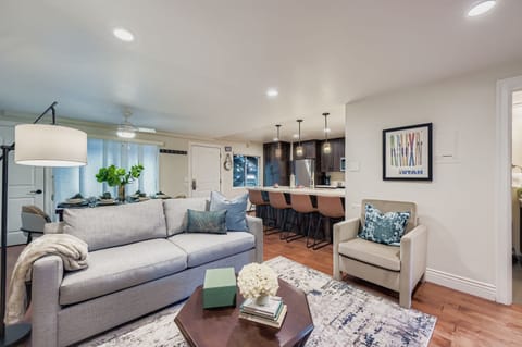 Relax in your thoughtfully designed living space, where modern comfort meets style with plush seating and an open kitchen perfect for unwinding.