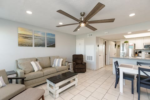 Relax in your open-concept retreat with beach artwork, comfy seating, and coastal vibes throughout your spacious living area.