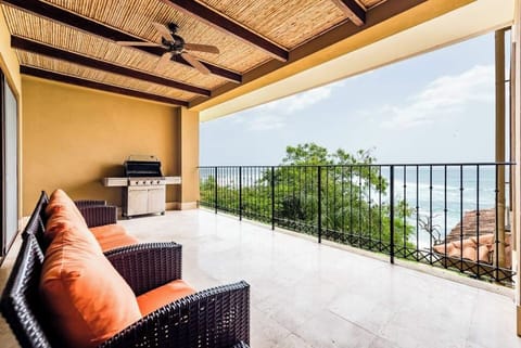 Expansive balcony with BBQ grill and panoramic ocean views. Perfect for sunset dinners and tropical relaxation. Located in a luxury Tamarindo condo near Langosta Beach with private beach access and upscale amenities.