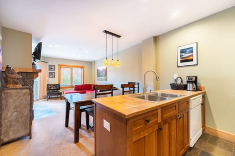 Relax in your open-concept space where warm wood finishes and pendant lighting create the perfect atmosphere for cooking and unwinding together.