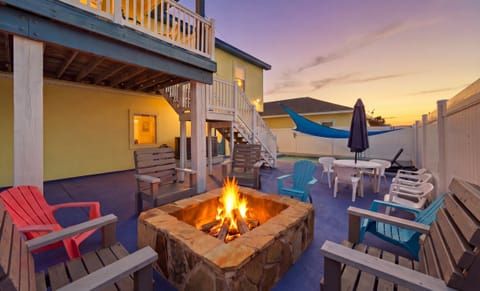 Fire pit at sunset with Adirondack chairs — perfect for evening gatherings
