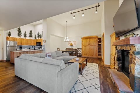 Spacious living room with a mounted TV, gas fireplace, queen sleeper sofa, and queen Murphy bed.