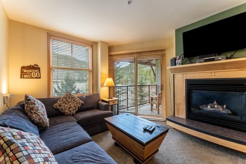 Cozy up by your crackling fireplace while mountain views frame your perfect retreat through oversized windows.