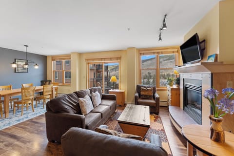 Gather around the cozy fireplace in your mountain retreat, where leather seating and stunning valley views create the perfect backdrop for memorable evenings.
