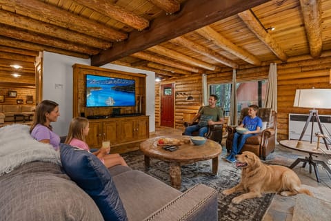 Gather with your loved ones in the cozy living room, where rustic wood beams and comfortable seating invite you to relax and enjoy quality time together.