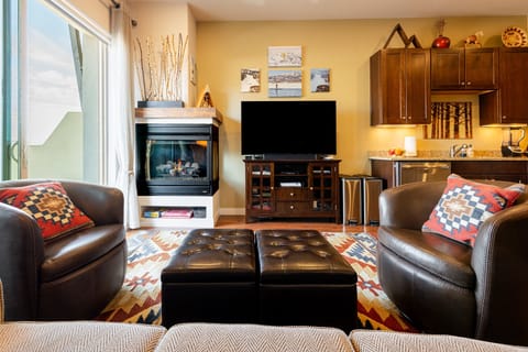 Inviting lounge with fireplace and entertainment center.