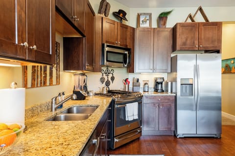 Fully equipped kitchen with granite counters and stainless appliances.