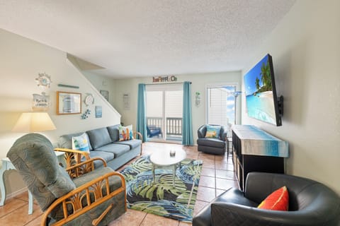 Sink into coastal comfort in your spacious living area, where tropical touches and ocean views create the perfect beach getaway atmosphere.