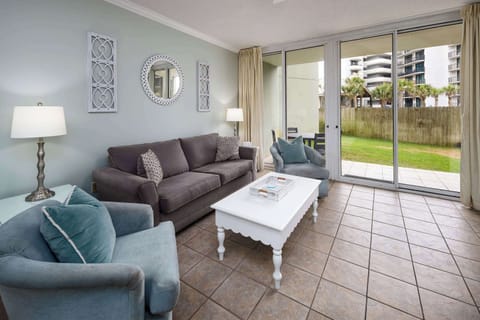 Living room with floor-to-ceiling sliders to the back patio