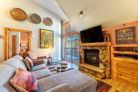 Cozy up by your stone fireplace while mountain views frame your perfect retreat through large windows.