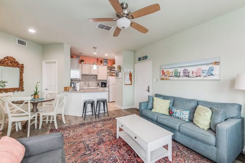 Relax in your bright, coastal-themed living space with comfortable seating and open kitchen perfect for your beach getaway.