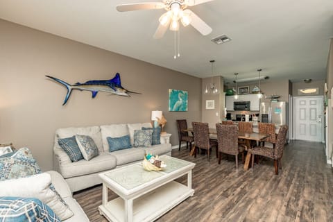 Your coastal-themed living space features comfortable seating and ocean-inspired decor, perfect for relaxing after beach adventures.
