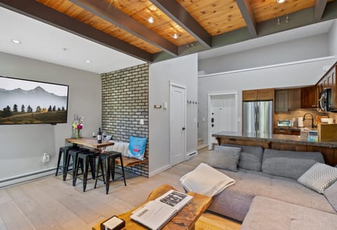 A nice open concept for living and dining. The dine at the handcrafted table and use the kitchen for extra seating.