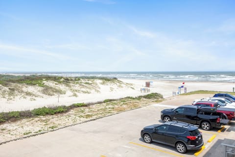 Convenient beachfront parking provides easy access to pristine sandy shores and rolling ocean waves.