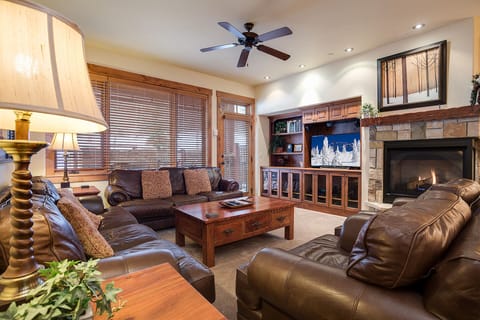 Sink into plush leather chairs by the crackling fireplace. Rich wood tones and warm lighting create your perfect mountain retreat sanctuary.