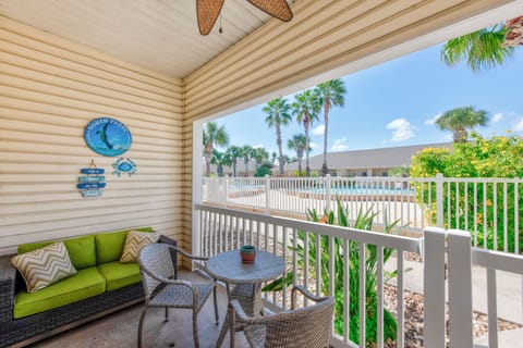 Relax on your covered balcony with tropical views, complete with comfy seating and coastal-themed decor for morning coffee or sunset lounging.
