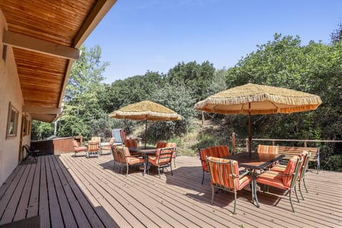 Huge private back deck with plenty of seating for entertaining, and well as private hot tub