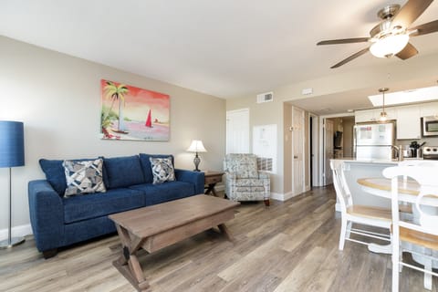 Relax in your spacious open-concept living area with comfortable seating, beach-inspired décor, and a queen size sleeper sofa.