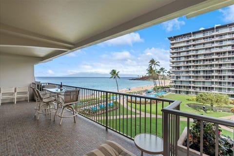 Your private lanai offers sweeping views of the turquoise ocean, sandy beach, and lush tropical gardens with swaying palms—perfect for morning coffee or sunset cocktails.